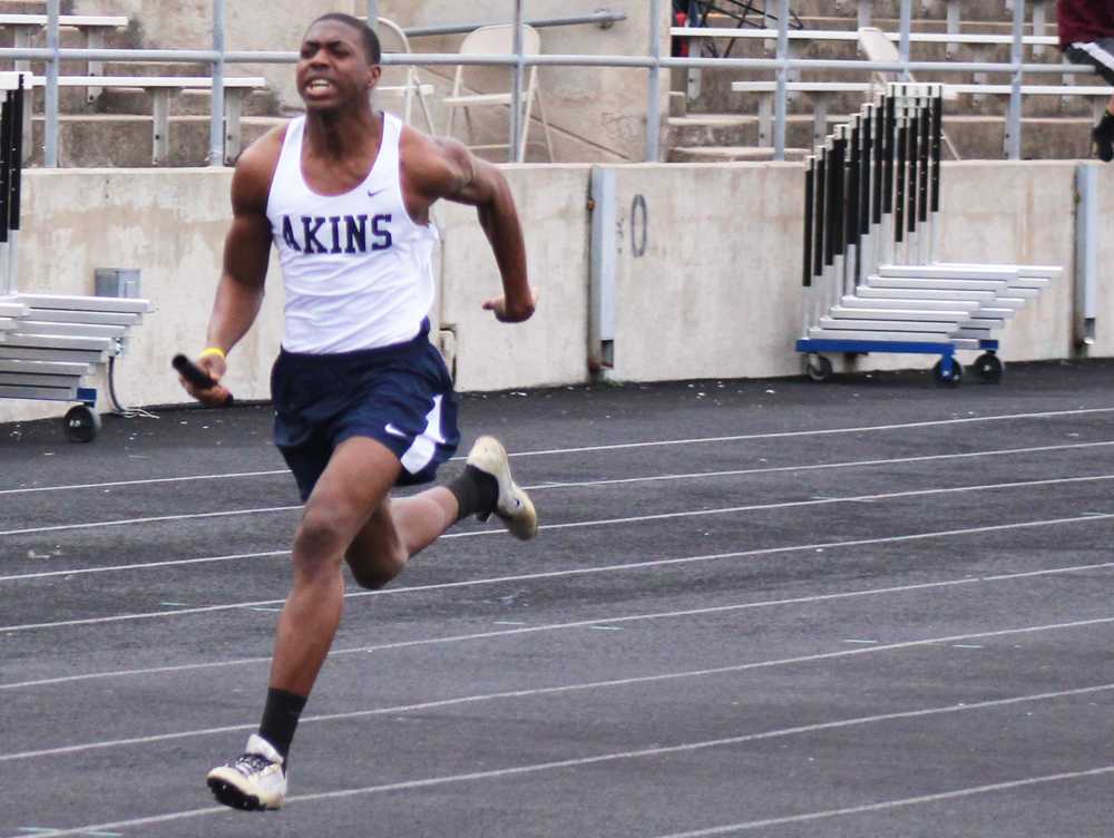 Senior Vincent Ifeanacho sprints his way to the finish line during his groups relay race. The track meet took place at Burger Stadium in the beginning of April. 