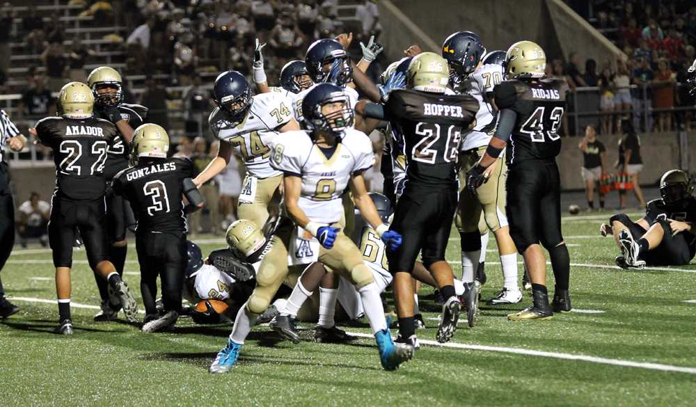 The+Akins+varsity+football+offense+celebrates+after+a+last+minute+touchdown+to+take+the+lead.+The+Eagles+finished+the+game+with+a+26-23+season+opener+victory+over+the+Crockett+Cougars.+