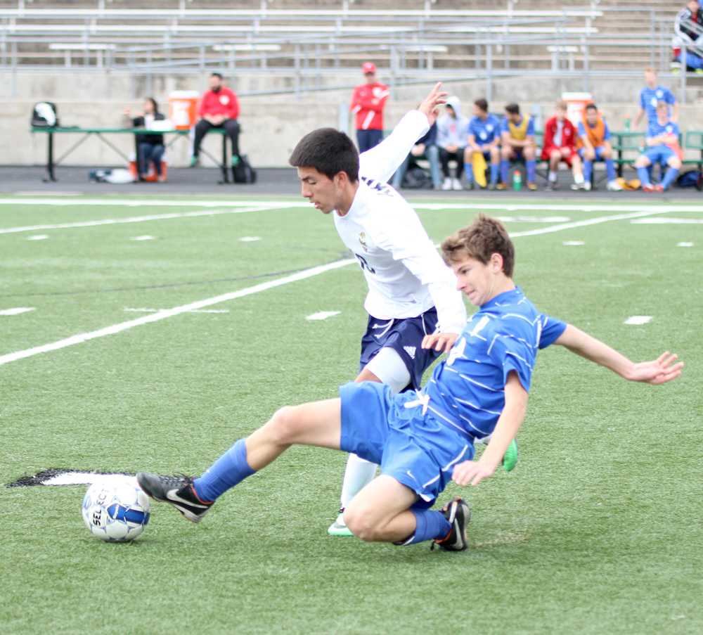 Senior midfielder Carlos Gutierrez eludes the Westlake opponent’s slide tackle. The Eagles lost to Westlake by a dissapointing 4–0. 