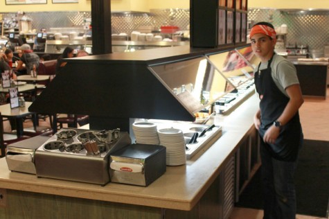 Senior Douglas Stewart cleans up the salad bar at Jasons Deli, working his late night shift. 