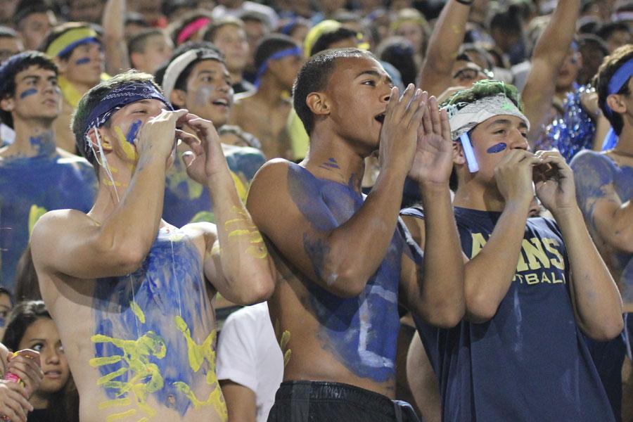 Seniors Ty Snyder, Isaiah Ramdeen, and Christian Martinez join in the chant of varsity quarterback Ryan Medrano’s name, who was sidelined due to an injury. “We had school spirit, it was crazy, and I’m glad everyone got out there,” senior Christian Martinez said. Students hope to replicate the crowd they had at homecoming in future games. 
