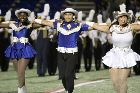 Junior Jorge Rocha performs during halftime show during the game as a member of the Diamond Dazzlers.