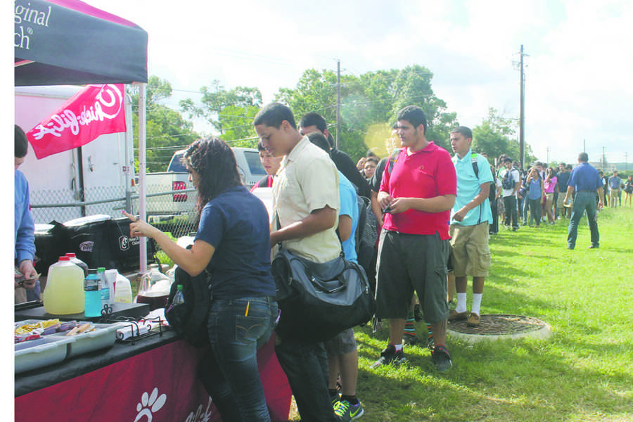 Students+are+waiting+in+a+long+line+for+their+Chick-fil-a+food.+Mr.+Gonzalez+is+supervising+the+kids+as+they+are+getting+their+lunch.