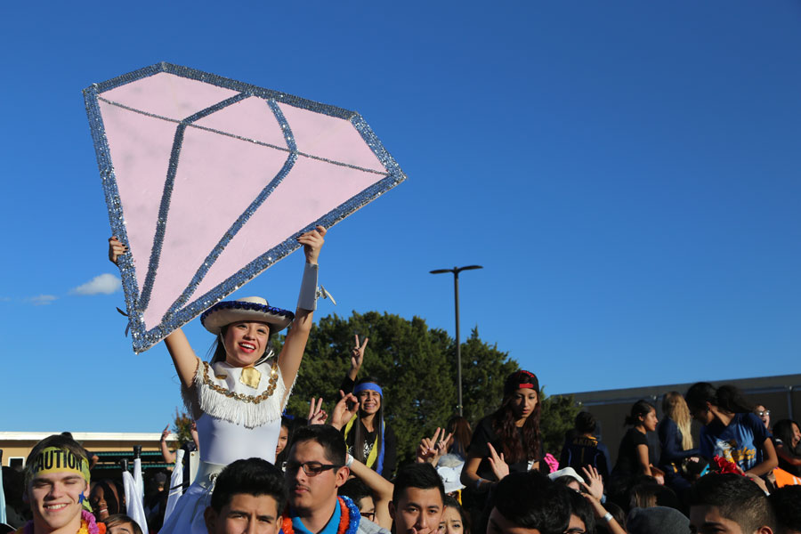 Senior Ariana Capetillo sits atop the crowd during the courtyard scene of the lip dub. The lip dub toured the first floor of the main building and ended in the courtyard. 