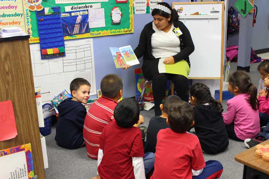 Junior Estefani Rodriguez is reading a book to the young children at Menchaca Elementary, preparing for the years ahead of her. 