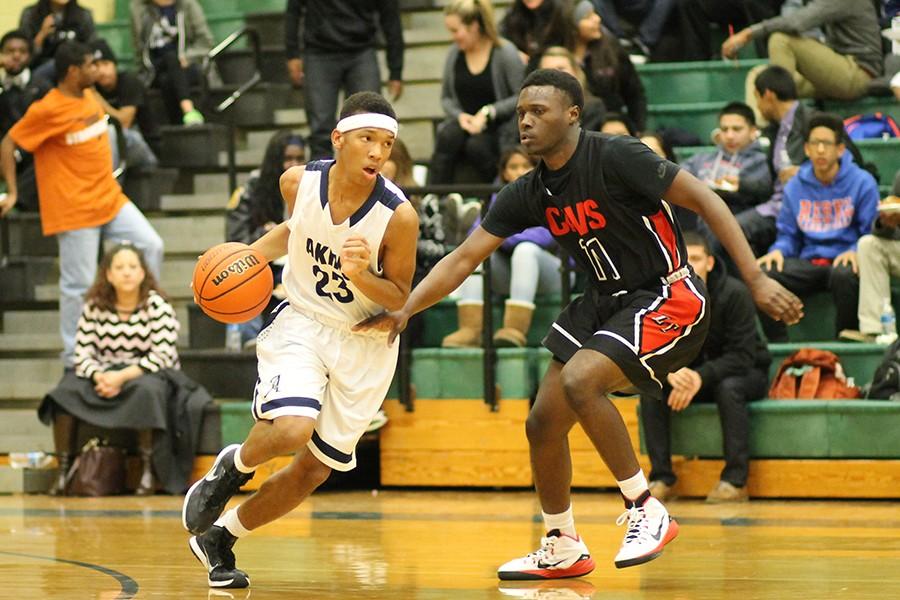 Sophomore Cameron Ivey makes a run as he’s being defended by a Lake Travis High School player. Akins won 67-66, in a very close game.