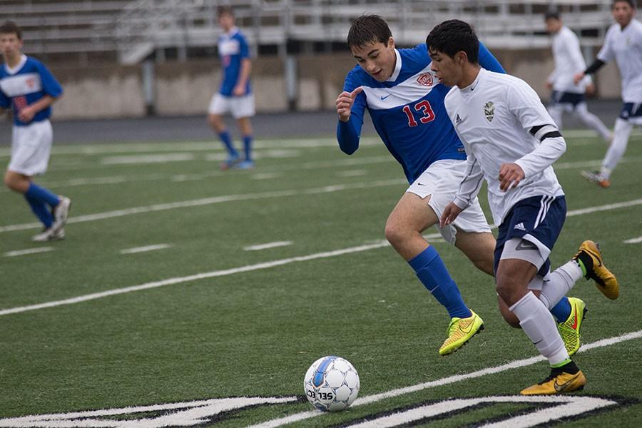 Senior Sergio Ruvalcaba takes the ball down field while being closely tailed by a Westlake player. The Eagles eventually suffered a 5-0 loss.