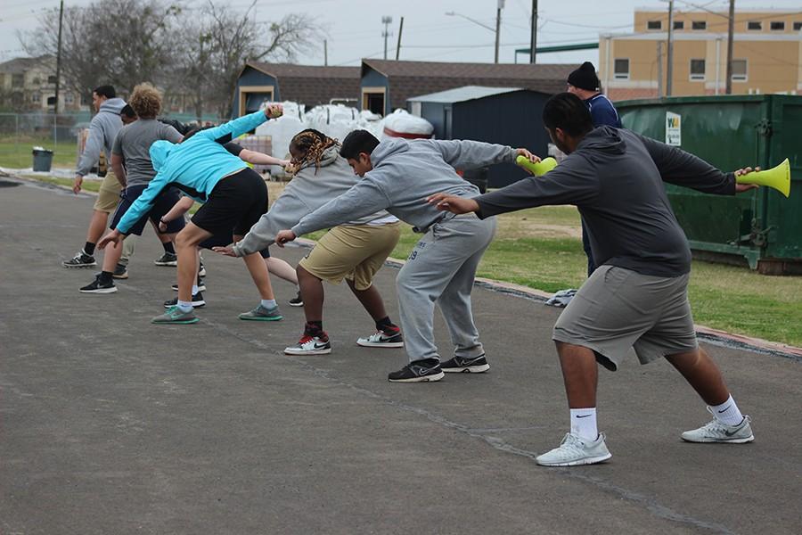 Members of the track team practice at the Akins track which is currently being resurfaced. Many of the team is bussed to Paredes Middle School, where they events practice that require an actual track in order to practice.