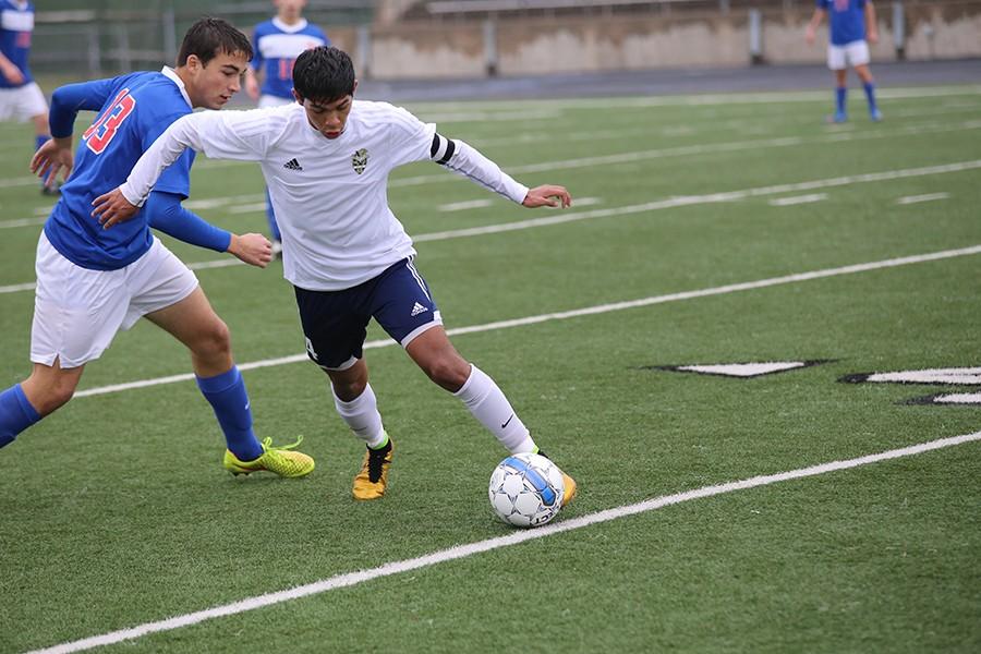 Senior Sergio Ruvalcaba defends the ball in a game against a player from Westlake High School. Akins lost the game 5-0. 