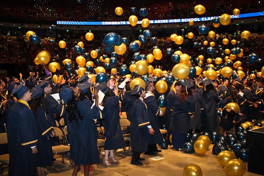 Members of the Class of 2014 enjoy the ballon drop during graduation ceremony at the Erwin Center.