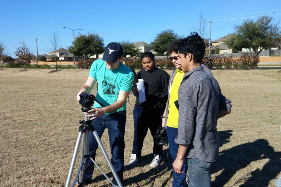 Doug Crabb shows seniors Javier DeLeon, Joshua Spence and Taylor Organ how to set up a shot for their film called School Boy. The student produced film, directed by junior Diego Rivera, was about a student overcoming a dark past through friendship. 