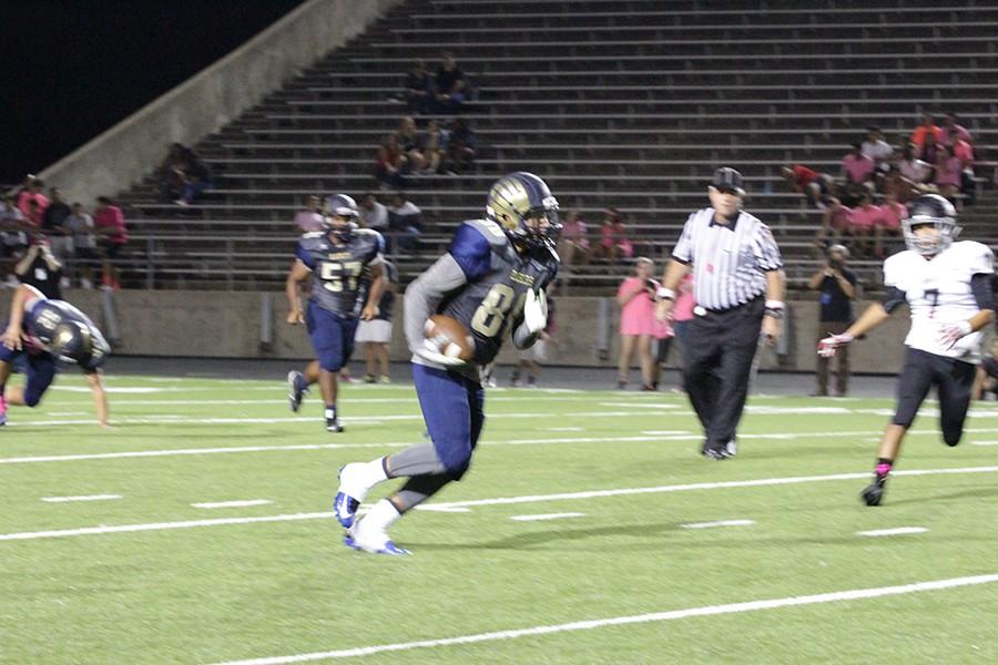 Wide Receiver William Cortinas #80 running the ball up the field. 
