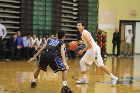 Point guard Vincent Prado faces an opponent while playing McCallum High School on Dec. 4. The team lost with a final score of 57 - 68.