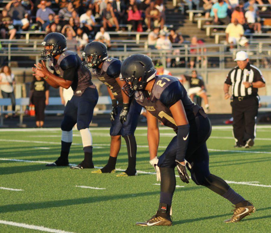 (left to right) QB Demarcus Cabezas, RB Kenan Lockhart, & WR Malcolm Rogers prepare to run the next play