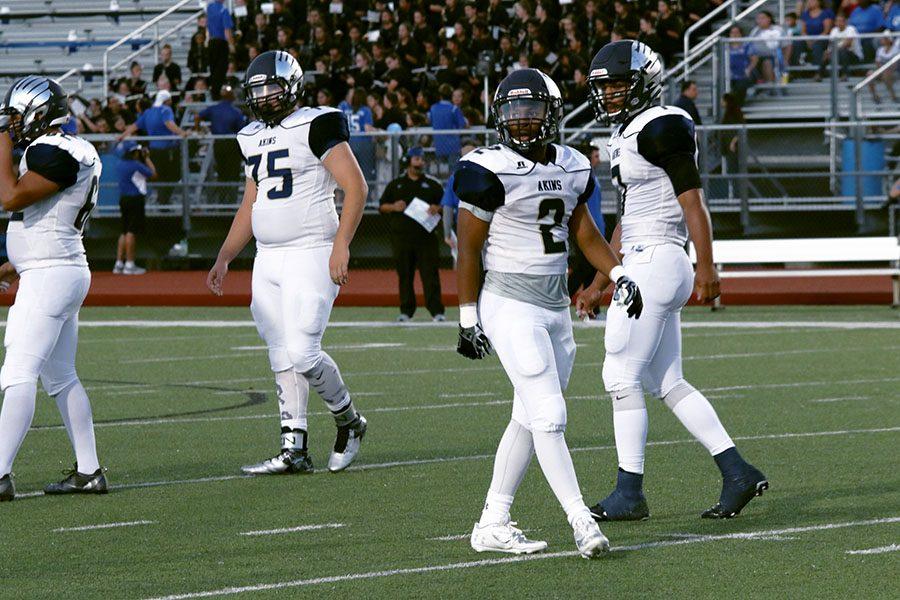( Right to Left ) Senior quarterback Demarcus Cabezas, Senior running back Kenan Lockhart, and Junior right tackle Austin Johnson get the play from their coach.