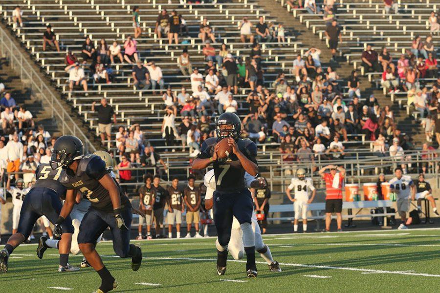 Sr. Demarcus Cabezas (7) positioned to throw a football.