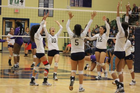 Akins varsity volleyball team celebrates during game against San Marcos Rattlers on 9/23/16.