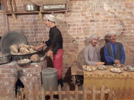 The Baghdadi Museum in Baghdad, Iraq has many exhibits showing example of life in Iraq before it was ravaged by years of war. In this exhibit a man cooks a lamb head for a big meal as they still do today.