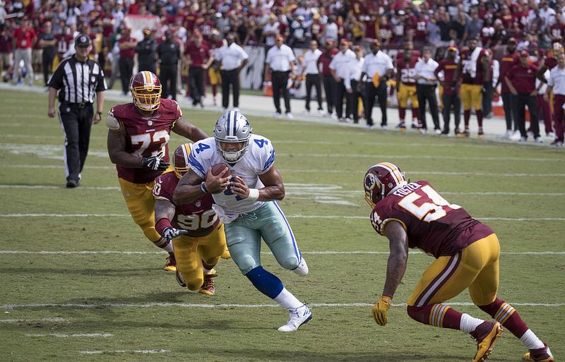 Quarterback Dak Prescott of the Dallas Cowboys runs for a touchdown in a game against the Washington Redskins at FedExField on September 18, 2016 in Landover, Maryland.