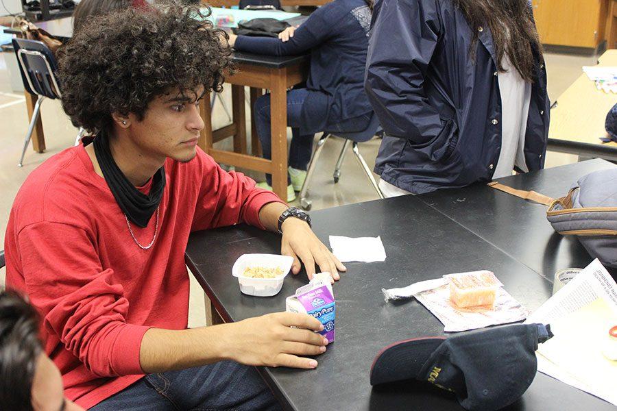 Sophomore John Mejia enjoying breakfast in the classroom
