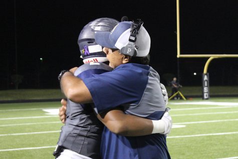 Love of the Game- Senior running back Kenan Lockhart hugs head football Coach Humberto Garza during game against Manor, which was the last of the season.