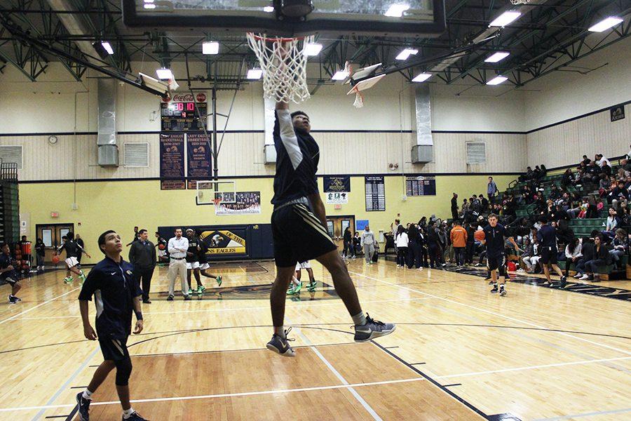 Larry Durden attempts to dunk in warm ups before the Lanier High School game in December.