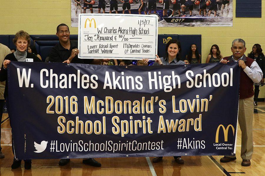 McDonalds+Restaurant+owners+present++Akins+Principal+Brandi+Hosack+with+a+check+for+%2410%2C000+on+Thursday+in+the+campus+gym.+The+money+was+awarded+after+Akins+won+first+place+in+a+social+media+school+spirit+contest+that+took+place+this+fall.