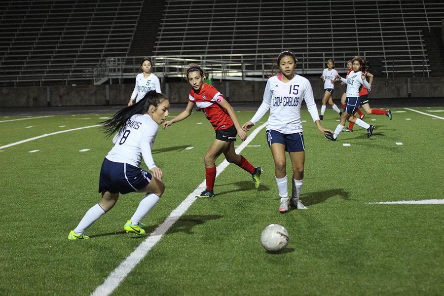 Captain Heidy Fuentes (right) and Itzel Moreno (left) work for possession of the ball against Del Valle. 