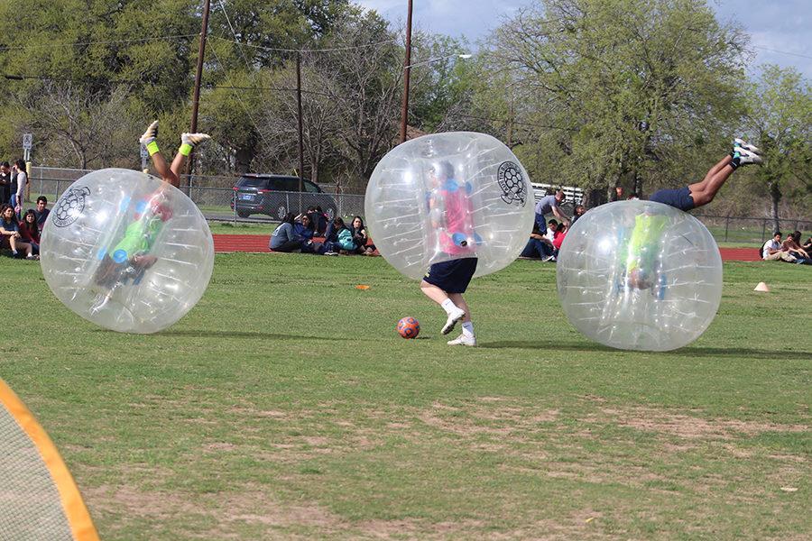 Two+players+roll+out+of+control+during+the+bubble+soccer+match+on+Thursday+on+the+practice+field.+Players+struggled+to+stay+on+their+feet+after+hitting+other+players+during+the+match.