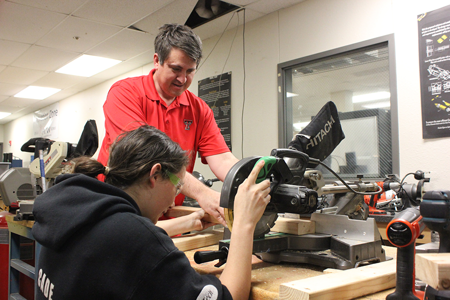 Science teacher David Stricklen and senior Mila Luna work on constructing a portion of the sandbox. Once completed, they were able to use a digital projection system to simulate topography lines in the sand.