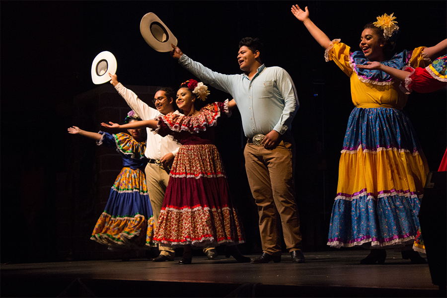 Ballet Folkloric performers wave to the audience as they finish their traditional dance performance.