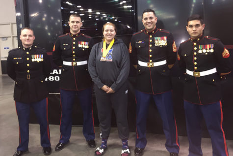 Katerina poses with Marine Corps soldiers, after earning the All-American title