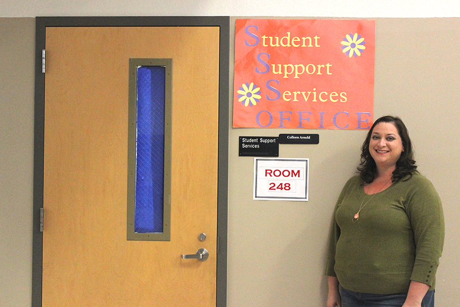 Social worker Colleen Arnold stands at her new SSS office in the red hall.