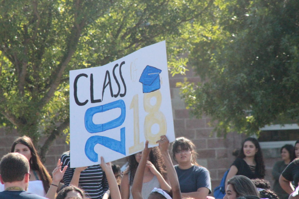 Akins students hold up the sign of their graduating class on September 14 in the courtyard. This was the first pep rally for the football game against Lehman High School.