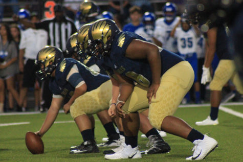 Akins offense lineman prepare to prepare to score, with the football in one of the players hands.