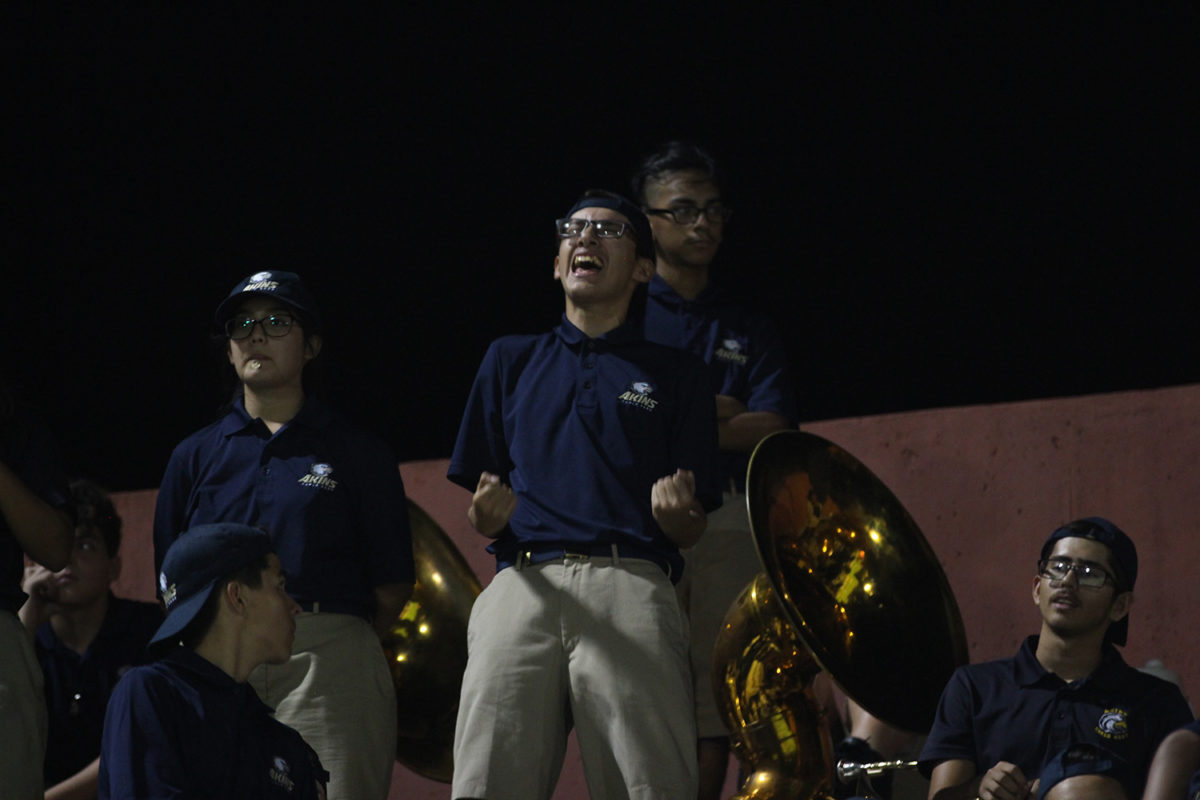 Sophomore Javier Arellano sings along to the other band’s stand tunes on September 21st at Housepark.