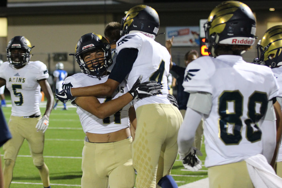 Senior Santana Castillo (11) and Senior Andy Zamora (4) celebrate a touchdown pass against McCallum on Sept. 21 at House Park. Despite the loss to the Knights, the Eagles found reasons to celebrate.