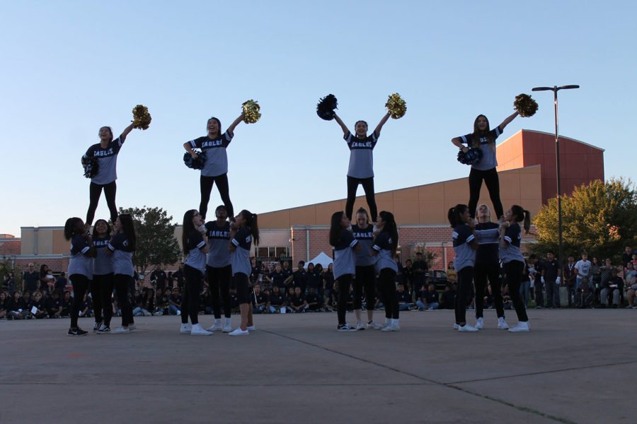 Akins Cheer perform in the courtyard and finish with a standing pose.