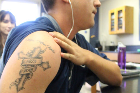  Senior Baylor Egdorf shows his first tattoo which is in
memory of his grandmother.