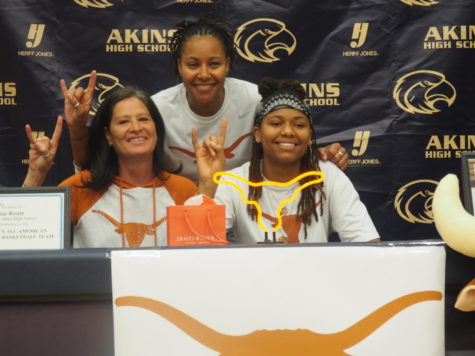 Shae Routt poses for a picture as she finished signing for the University of Texas at Austin.