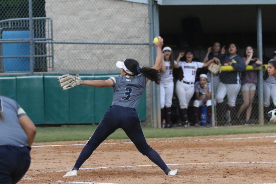 Senior Ivelisse Moreno throws a pitch for the opposing team’s batter. The varsity softball team was the district champion this season, with a 8-2 record for the year. 