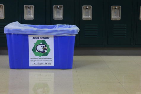 Newspaper advisor David Doerrs recycling bin which has a sign placing the responsibility to recycle on students