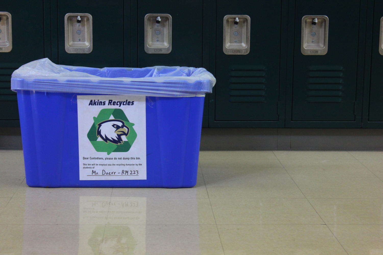 Newspaper advisor David Doerr's recycling bin which has a sign placing the responsibility to recycle on students
