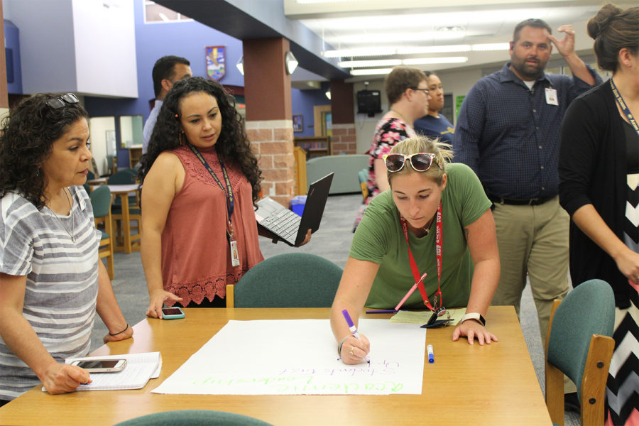 Akins teachers writing a list of qualities that are important for the new principal.