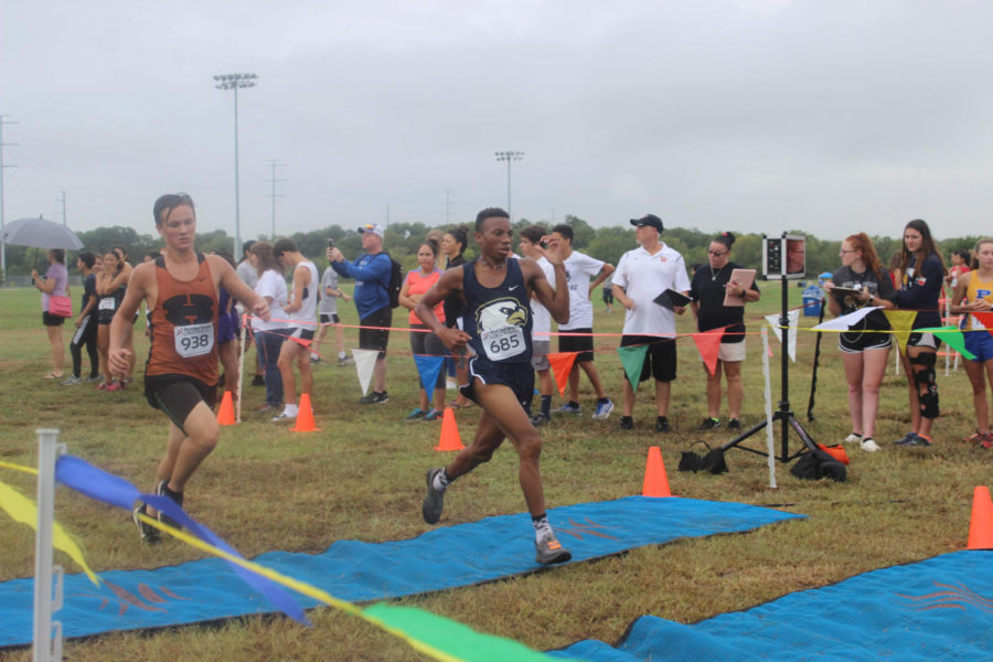 Senior JJ Adams crosses the finish line at the Pflugerville meet on Sept. 6. Adams placed in top 30 of 200. 