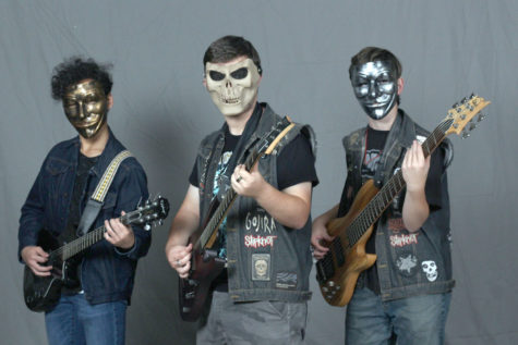 Junior Dee Carreon, sophomore Sam Dobbs and senior Ben Dobbs don masks as part of their look for their metal band Jaded Black. The band is working to produce their first album scheduled to be released around April of 2019.