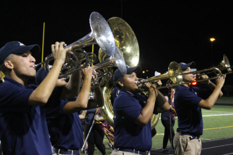 A group of band members playing on the field during halftime.
They performed at the Akins and Crockett game.