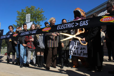 Students stand with Austin City Council member Ann Kitchen as Jackie Sargent cuts the ribbon with Austin Energy mascot Stevie the T-rex. The ceremony was held on Nov. 14 during FIT.