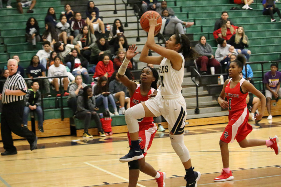 Senior Kianna Haider lifts off for a layup shot in the game against the Del Valle Cardinals.