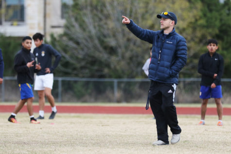 Boys Varsity soccer team Head coach Chad Timmons gives directions to soccer players during practice. Timmons is the new head coach this year.